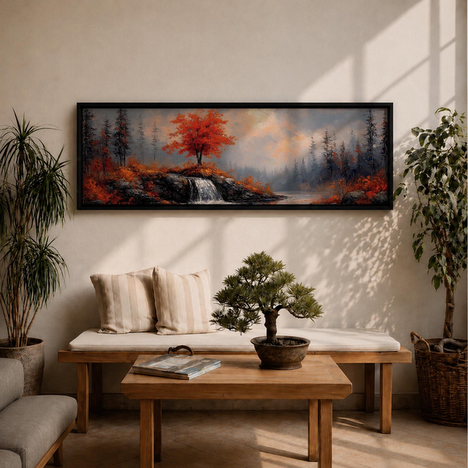 A long panoramic landscape painting showing a small waterfall flowing over rocky cliffs beneath a vivid red autumn tree. Surrounding forest trees fade into misty blue tones while bright fall foliage and rugged stones frame the stream, forming a tranquil woodland scene across a wide horizontal composition.