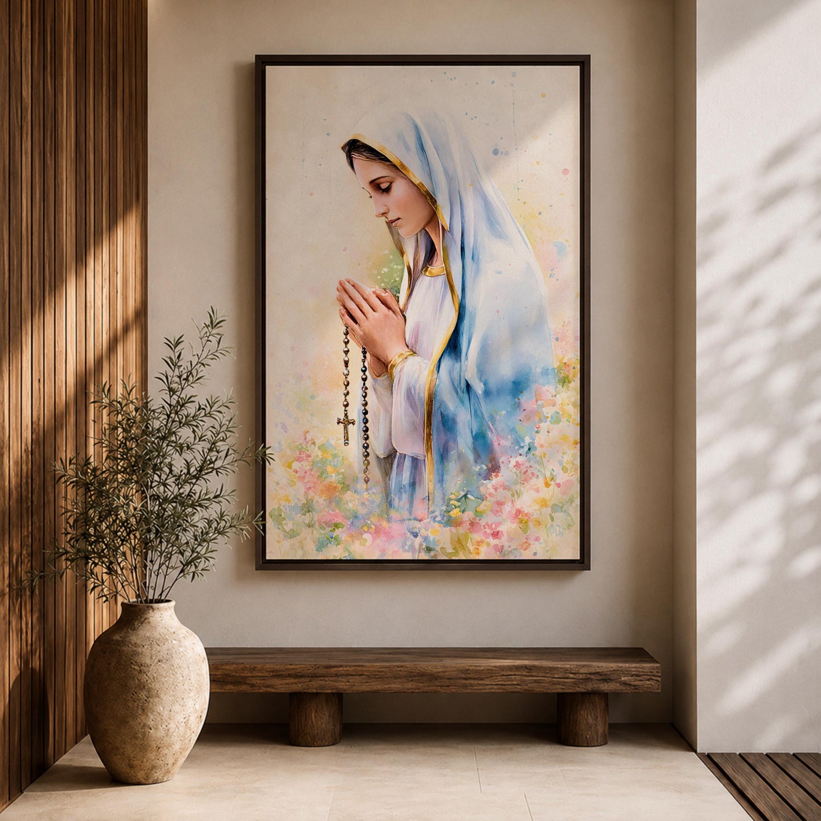 A watercolor style framed canvas depicting Virgin Mary in profile, wearing a blue and white veil with gold trim, holding a rosary and praying, surrounded by soft floral colors and a gentle light background.
