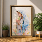 A watercolor style framed canvas depicting Virgin Mary in profile, wearing a blue and white veil with gold trim, holding a rosary and praying, surrounded by soft floral colors and a gentle light background.