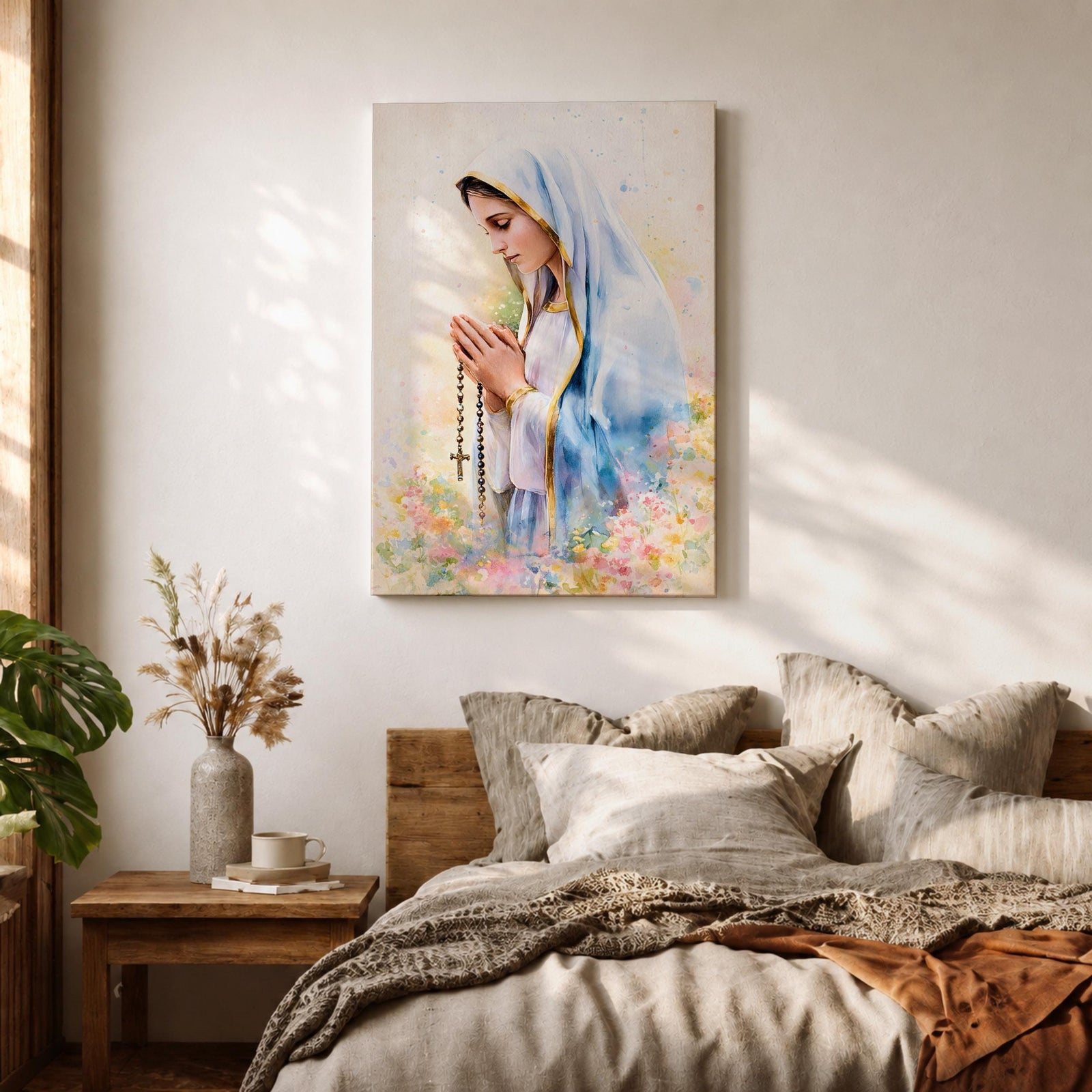 A watercolor style framed canvas depicting Virgin Mary in profile, wearing a blue and white veil with gold trim, holding a rosary and praying, surrounded by soft floral colors and a gentle light background.