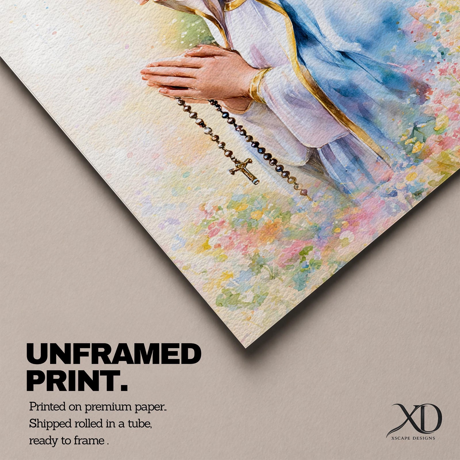 A watercolor style framed canvas depicting Virgin Mary in profile, wearing a blue and white veil with gold trim, holding a rosary and praying, surrounded by soft floral colors and a gentle light background.