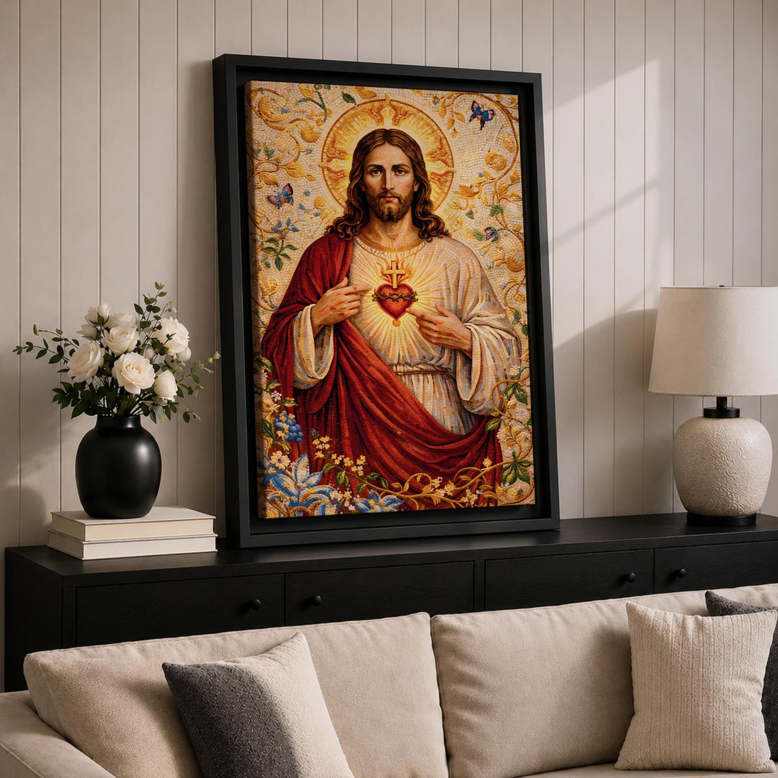 A detailed mosaic-style artwork depicting the Sacred Heart of Jesus with a glowing heart encircled by thorns and a cross above it. Jesus is shown with long hair and a beard, wearing a red and white robe, surrounded by floral and butterfly motifs in a radiant golden background.