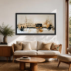 A panoramic painting of the Kaaba at Masjid Al Haram in Mecca, depicted within a sacred mosque setting with surrounding architectural forms and a soft abstract atmosphere, rendered in layered brushstrokes that emphasize depth, light, and spiritual presence across a wide composition
