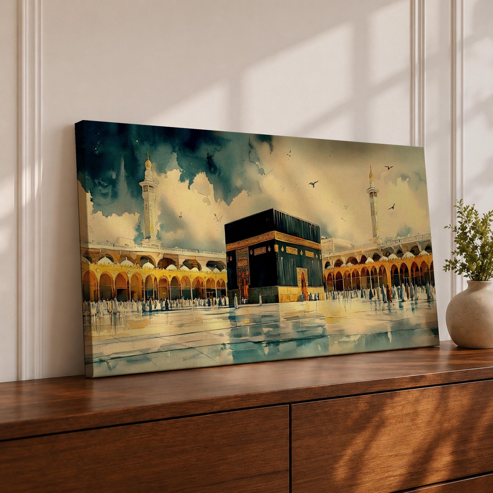 A panoramic watercolor style painting of the Kaaba at Masjid al Haram centered within an open courtyard, surrounded by arched colonnades and tall minarets, with soft blended tones, fluid brushwork, and reflections on the ground creating depth, movement, and a serene interpretation of sacred architecture.