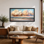 A panoramic impressionist seascape painting of ocean waves rolling onto shore beneath a vast sky filled with large dramatic clouds in soft peach, cream, and blue tones, with textured brushstrokes capturing light reflecting across the water and horizon, creating a serene yet dynamic coastal atmosphere.