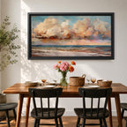 A panoramic impressionist seascape painting of ocean waves rolling onto shore beneath a vast sky filled with large dramatic clouds in soft peach, cream, and blue tones, with textured brushstrokes capturing light reflecting across the water and horizon, creating a serene yet dynamic coastal atmosphere.