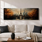 A long narrow panoramic painting depicts the Eiffel Tower rising above a river with an arched bridge in the foreground, surrounded by autumn trees and a distant city skyline, rendered in textured brushstrokes with warm golden tones and soft reflections that create depth and a romantic atmospheric cityscape.