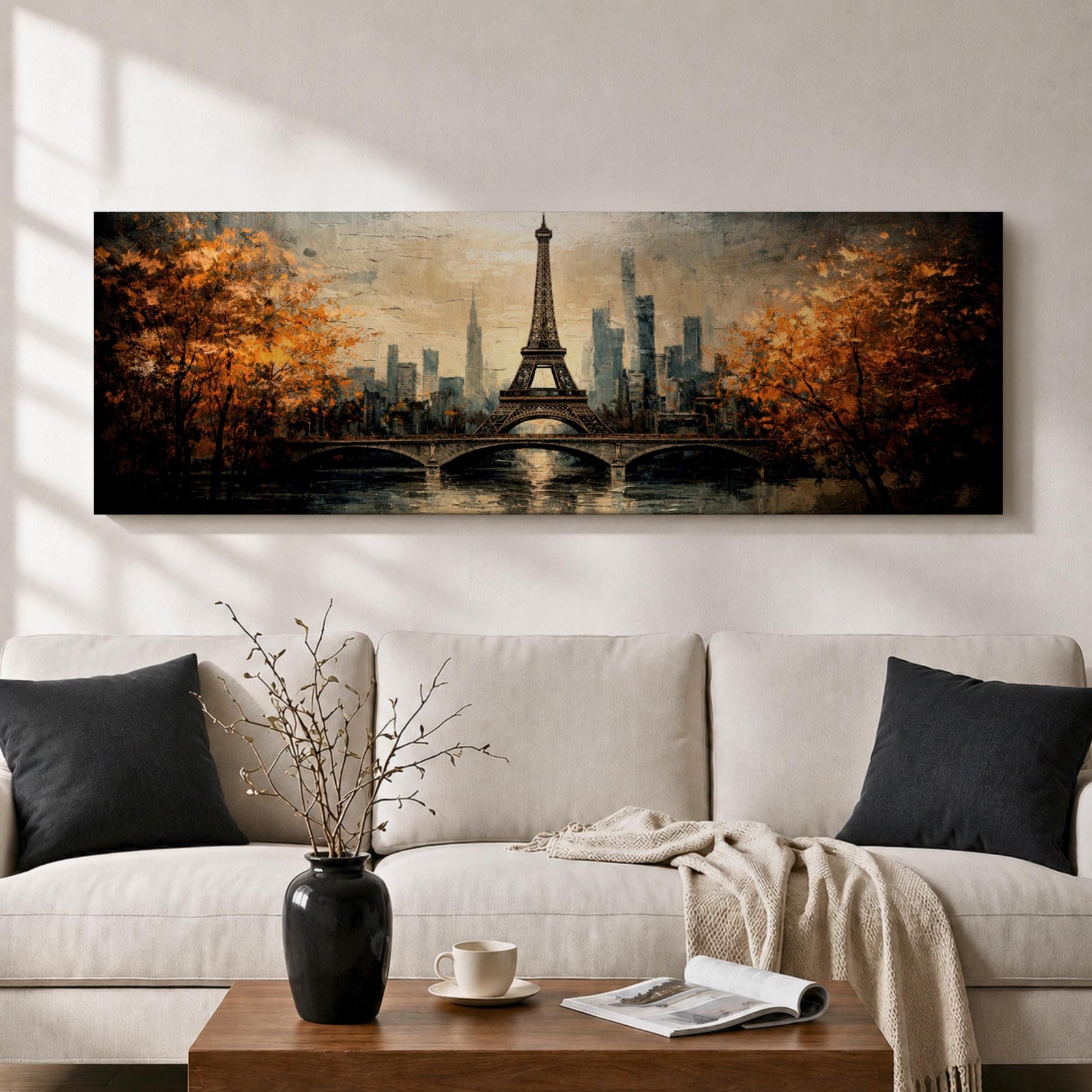 A long narrow panoramic painting depicts the Eiffel Tower rising above a river with an arched bridge in the foreground, surrounded by autumn trees and a distant city skyline, rendered in textured brushstrokes with warm golden tones and soft reflections that create depth and a romantic atmospheric cityscape.