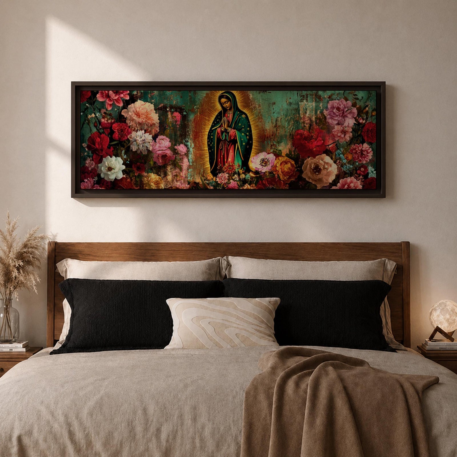 A long narrow panoramic painting shows Virgen de Guadalupe centered in prayer within a radiant halo, surrounded by richly detailed blooming flowers, with textured abstract layers and deep earthy tones blending with vibrant florals to create depth, contrast, and a luminous devotional focal point in an expressive style.