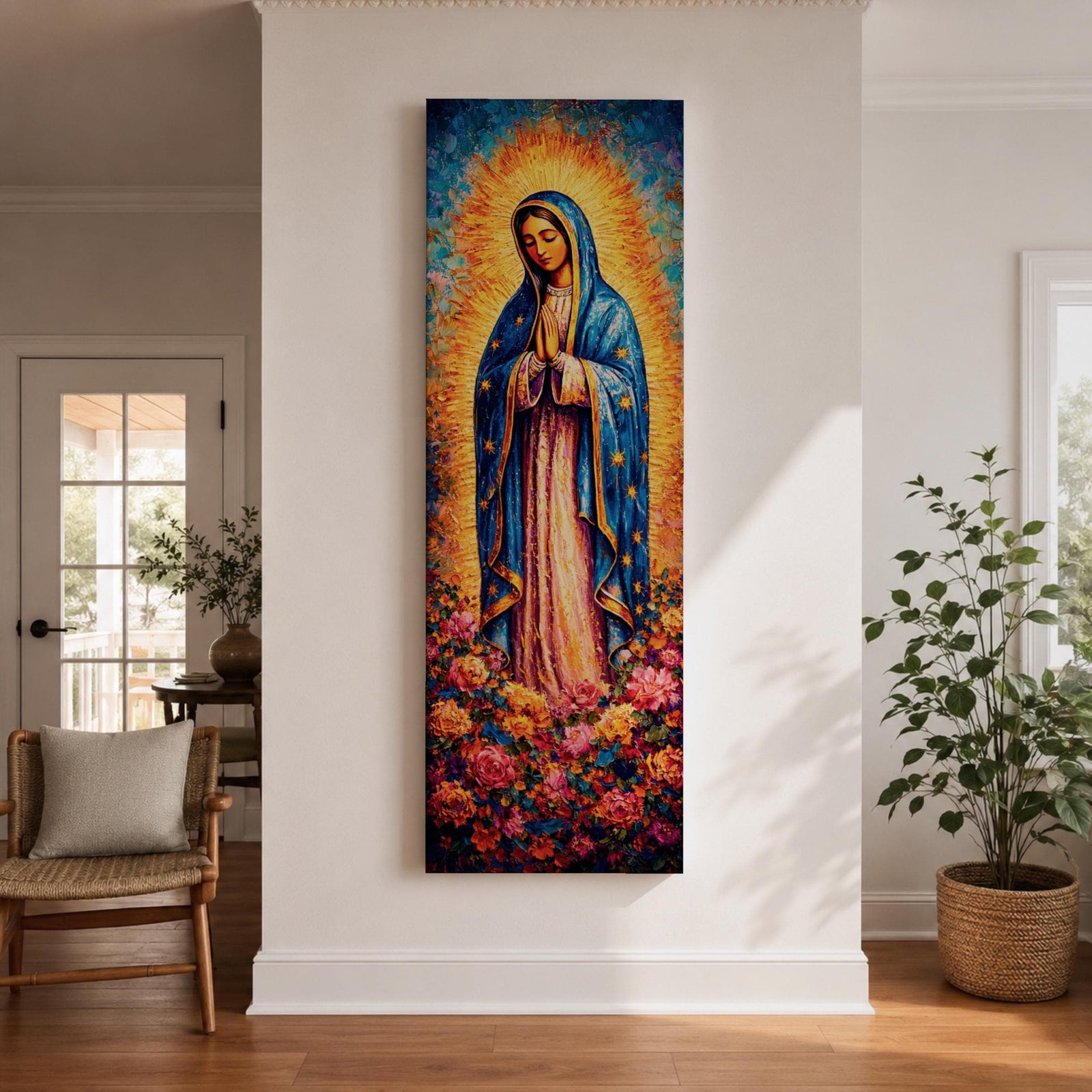 A tall narrow vertical depiction of Our Lady of Guadalupe standing in prayer with hands clasped, wearing a blue star covered mantle and soft pink gown, surrounded by a radiant golden sunburst and dense vibrant floral arrangement at her feet, rendered with rich texture and layered color in a devotional composition.