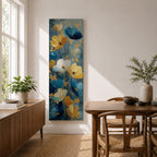 A tall, narrow vertical painting of stylized poppy flowers in layered teal, navy, gold, and soft white tones, featuring textured brushstrokes and metallic accents, with blooms rising along slender stems against a deep blue abstract background, creating a contemporary floral composition with rich contrast and flowing movement.