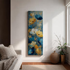 A tall, narrow vertical painting of stylized poppy flowers in layered teal, navy, gold, and soft white tones, featuring textured brushstrokes and metallic accents, with blooms rising along slender stems against a deep blue abstract background, creating a contemporary floral composition with rich contrast and flowing movement.