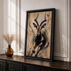 Striking gazelle wall art featuring a graceful antelope in motion with elegant curved horns against a contemporary abstract background. Wildlife artwork with dramatic black and gold tones, expressive splatter details, and luxurious gold accents, perfect for modern, safari, and nature-inspired interiors.