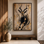 Striking gazelle wall art featuring a graceful antelope in motion with elegant curved horns against a contemporary abstract background. Wildlife artwork with dramatic black and gold tones, expressive splatter details, and luxurious gold accents, perfect for modern, safari, and nature-inspired interiors.