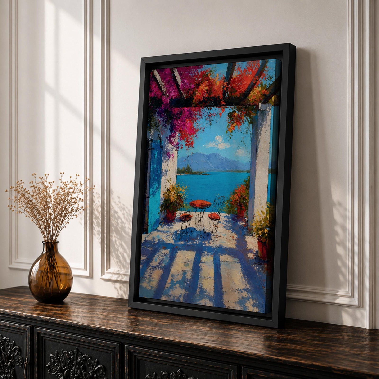 Vibrant Mediterranean patio wall art featuring a sunlit terrace with colorful bougainvillea, a café table and chairs, and a breathtaking blue lake view framed by white columns. Impressionist coastal artwork with rich colors, relaxing vacation ambiance, and European seaside charm.