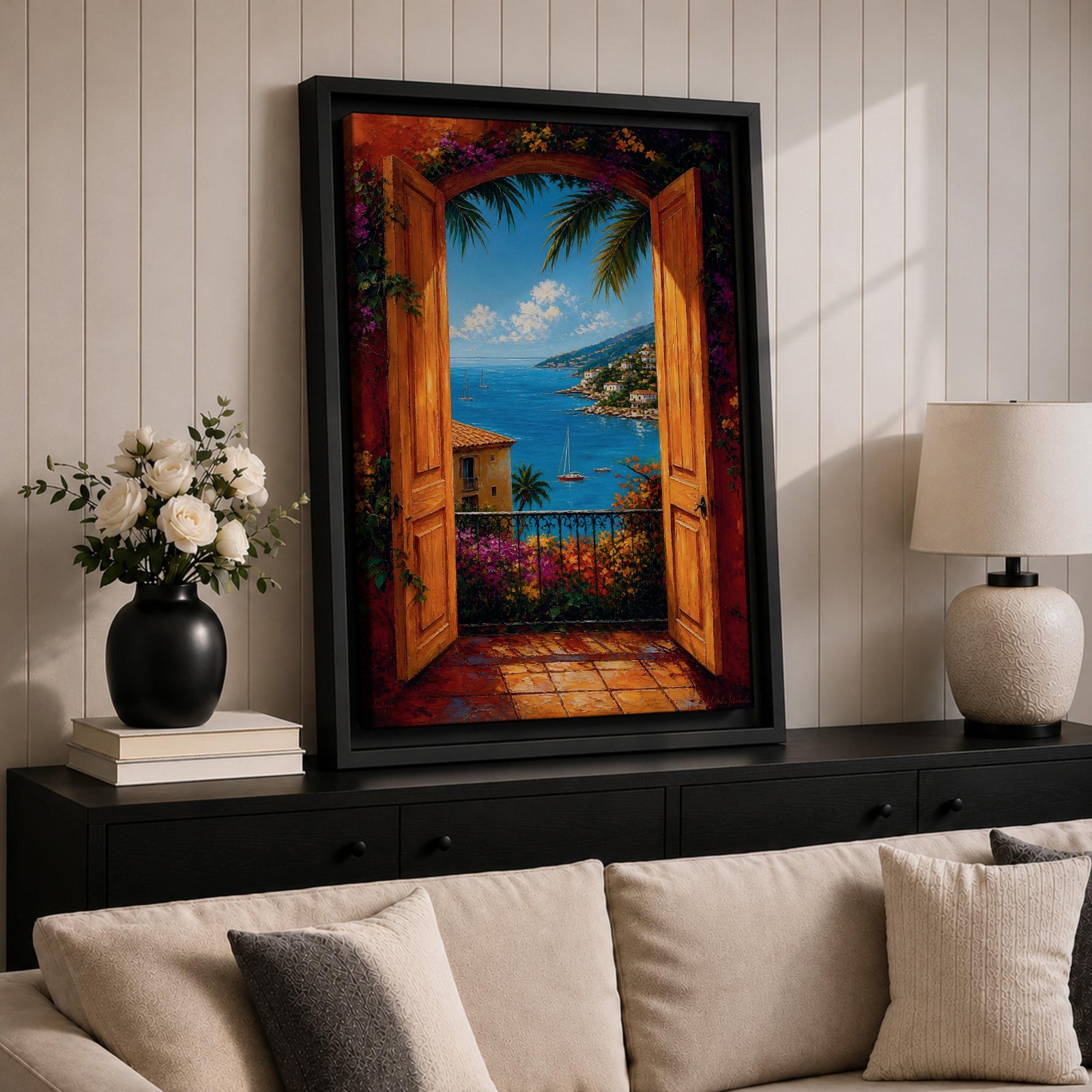 Mediterranean coastal landscape viewed through open wooden doors overlooking a bright blue sea. Colorful flowers, palm trees, sailboats, and hillside villas create a romantic Italian seaside scene in a vibrant impressionist framed canvas artwork.