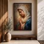 Sacred Catholic wall art featuring the Virgin Mary in prayer with hands clasped and eyes gently lowered. Soft golden light illuminates her serene expression, while rich blue garments and impressionist brushwork create a timeless devotional portrait ideal for prayer rooms and Christian homes.