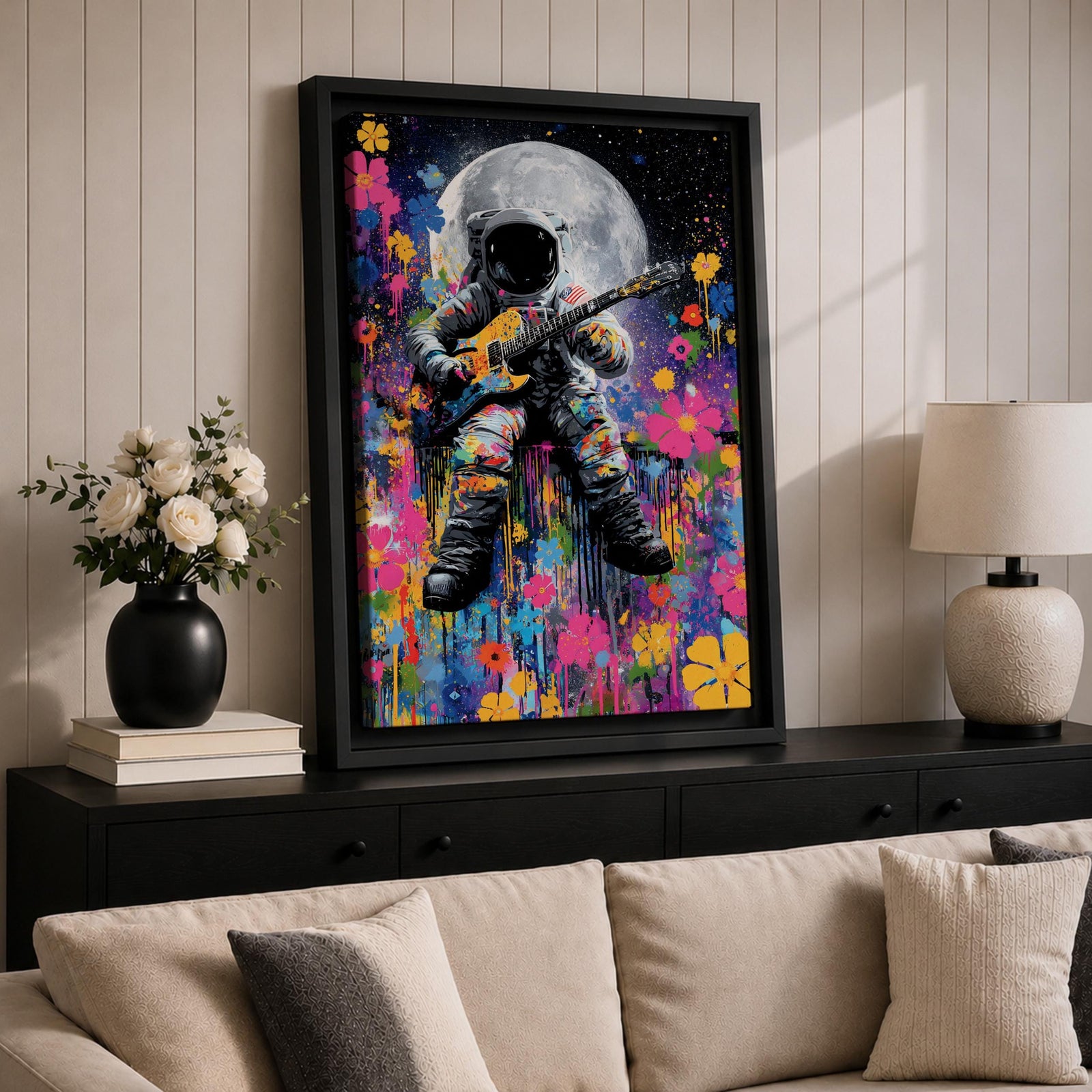 Colorful pop art painting of an astronaut playing an electric guitar with a large moon in the background, surrounded by vibrant splashes and floral patterns, set against a starry night sky.