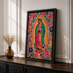 Our Lady of Guadalupe wall art featuring the Virgin Mary in prayer surrounded by vibrant floral folk art patterns and a radiant golden aura. Bright pink, blue, orange, and red blossoms frame this colorful Mexican Catholic artwork, creating a joyful devotional centerpiece for home décor.