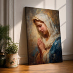 Sacred Catholic wall art featuring the Virgin Mary in prayer with hands clasped and eyes gently lowered. Soft golden light illuminates her serene expression, while rich blue garments and impressionist brushwork create a timeless devotional portrait ideal for prayer rooms and Christian homes.