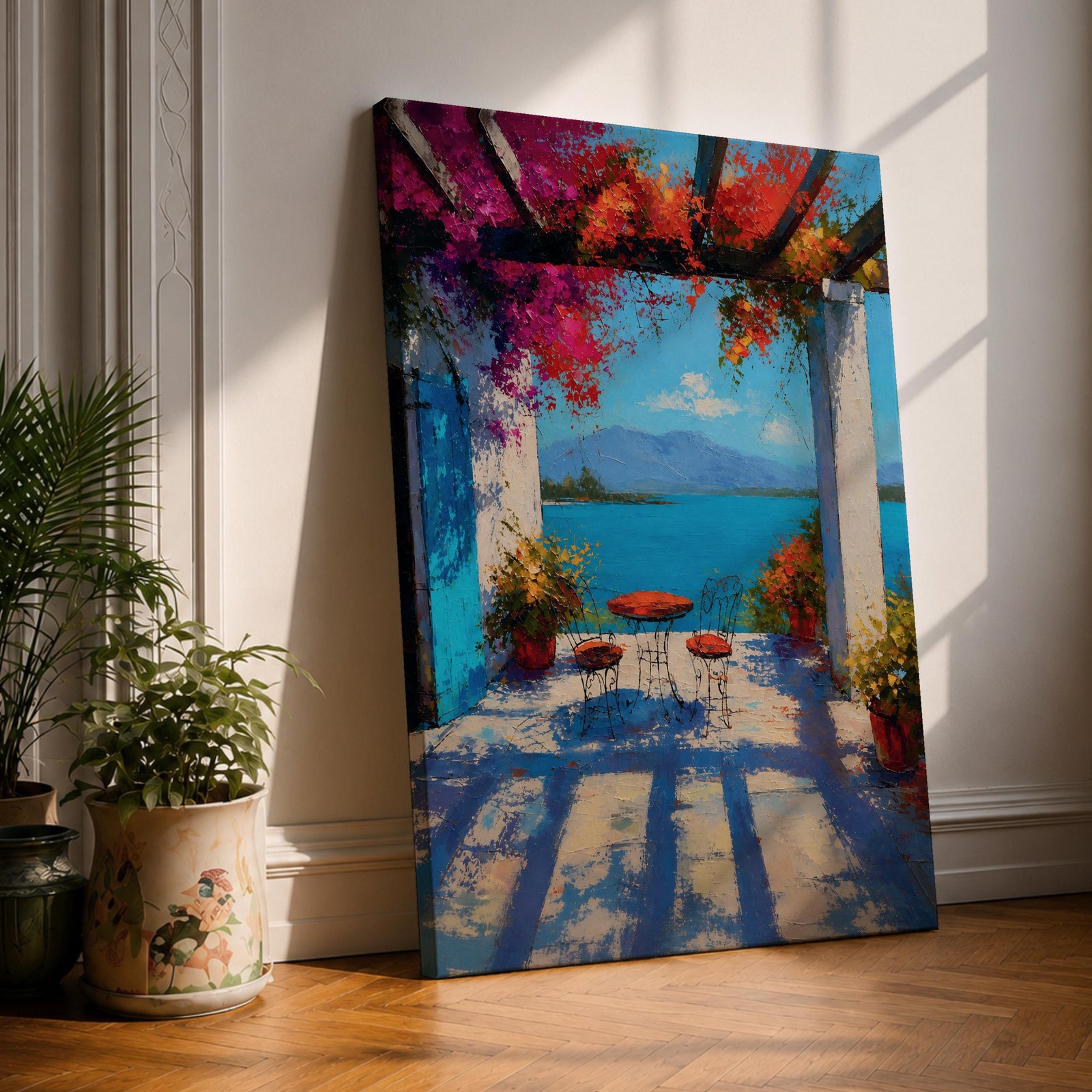 Vibrant Mediterranean patio wall art featuring a sunlit terrace with colorful bougainvillea, a café table and chairs, and a breathtaking blue lake view framed by white columns. Impressionist coastal artwork with rich colors, relaxing vacation ambiance, and European seaside charm.